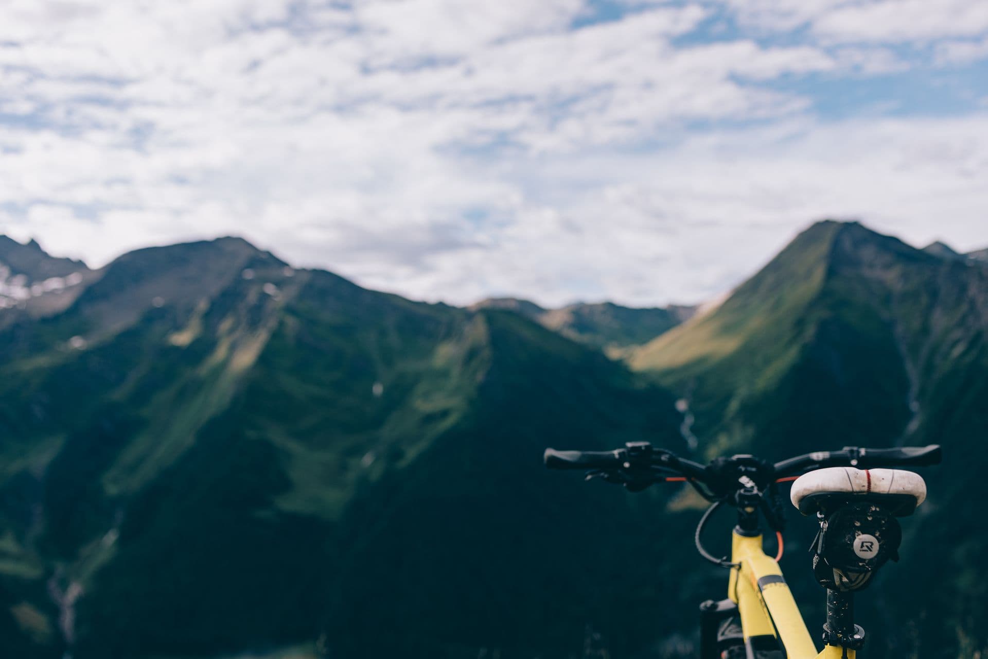 Fantonn bike on rocky trail with misty mountains